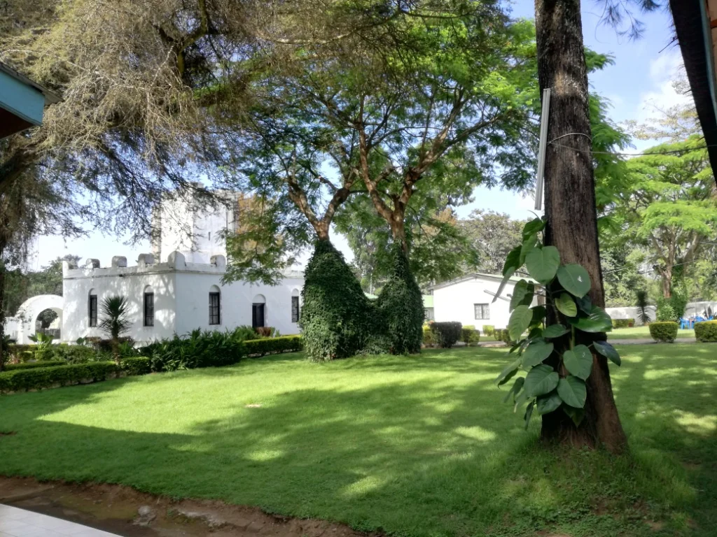 Leafy garden grounds beside the Boma museum buildings in Arusha.